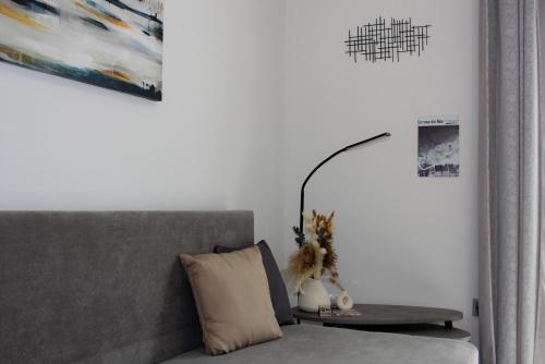 a lamp on a table next to a couch at Scalo del Mare Apartment in Keramoti