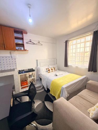 a small room with two beds and a couch at Ruiru Cozy stays in Ruiru