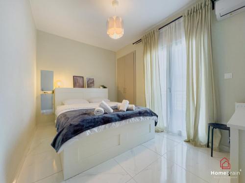 a bedroom with a bed and a large window at MOS luxury project by Homebrain in Alexandroupoli