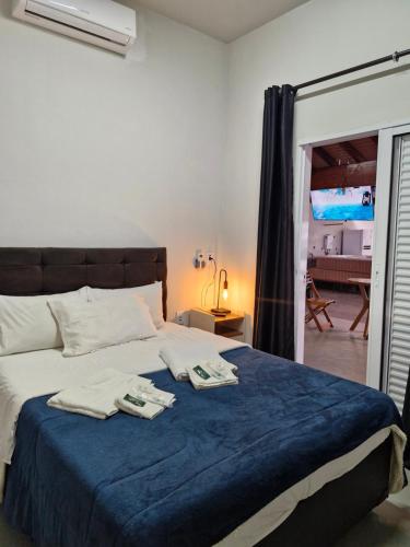 a bedroom with a bed with two towels on it at 2204 Chácara Pousada CadClub Quarto Suíte Para Casal in Sao Jose do Rio Preto