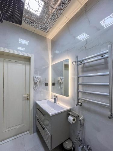 a bathroom with a sink and a mirror at Şimal Hotel in Quba