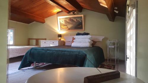a bedroom with a bed and a table in a room at Relaxing Gite aux fil de l'eau in Sainte-Colombe-sur-lʼHers