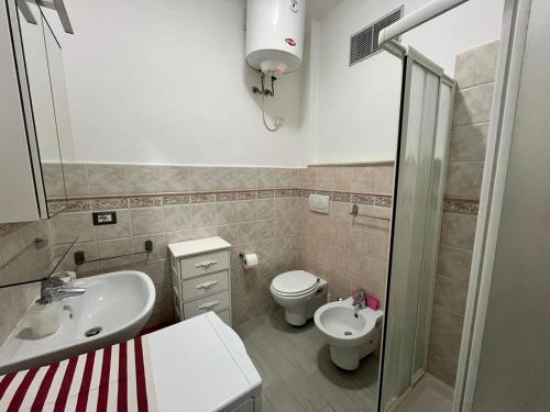 a bathroom with a sink and a toilet at Monolocale 3 Api in Portoferraio