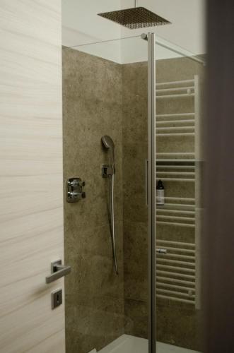 a shower stall with a glass door with a shower at Casa Vacanze Centrale in Mori