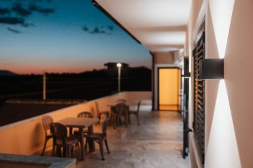 a balcony with tables and chairs on a building at Matteo Garden & Restaurant in Vlorë
