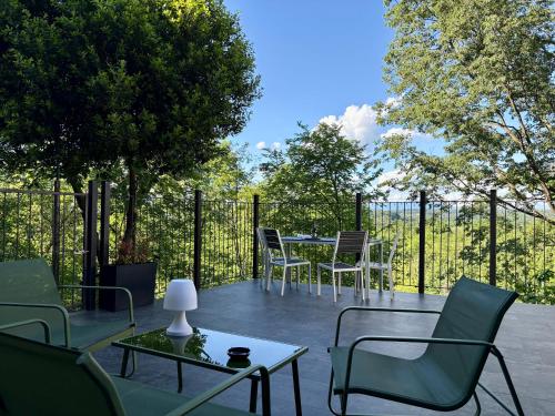 a patio with chairs and a table and a fence at The One Malpensa Rooms in Vizzola Ticino
