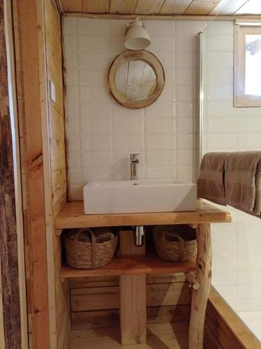 a bathroom with a sink and wicker baskets at Brescou Lodges in Murviel