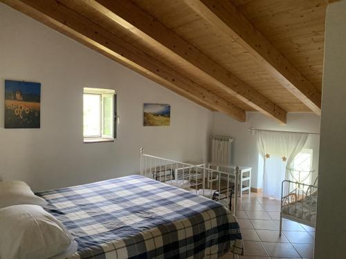 a bedroom with a bed with a blue and white blanket at B&B Da Mariella in Spigno Saturnia