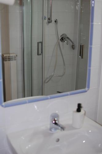 a bathroom sink with a shower and a mirror at B&B Da Mariella in Spigno Saturnia