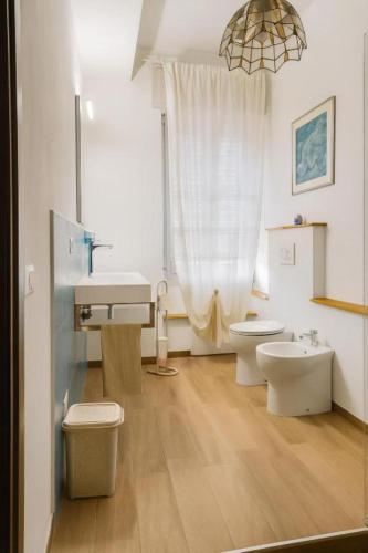 a bathroom with two toilets and a sink at Torres House Suite & Rooms in Sassari