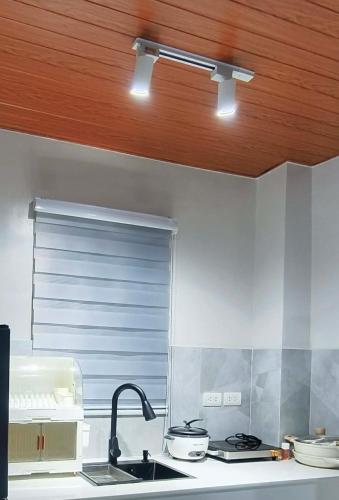 a kitchen with a sink and a wooden ceiling at Engil's Studio in San Jose Dinagat Islands Philippines in Bulawan