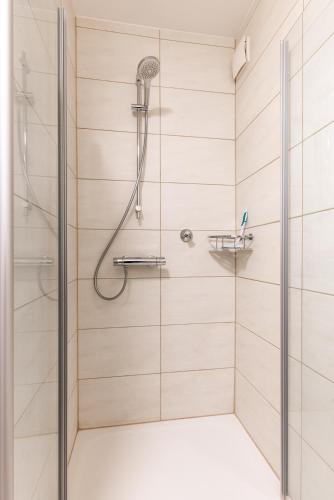 a shower with a shower head in a bathroom at Apartment in Bayreuth in Bayreuth