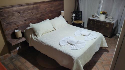 a bedroom with a bed with two towels on it at Namasté in Villa Larca