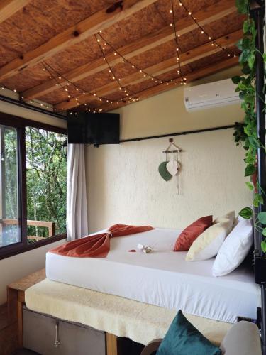 a bedroom with a large bed in a room at Recanto Vista Verde in Nova Petrópolis