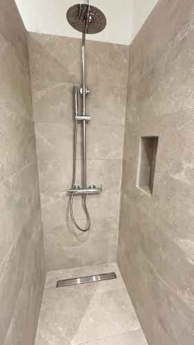 a shower with a shower head in a bathroom at Villa Panorama Astrakeri Beach in Astrakeri