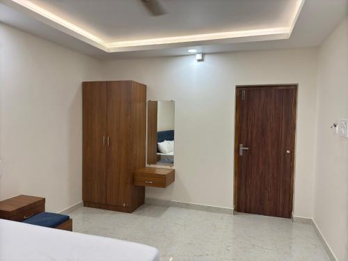 a bathroom with wooden cabinets and a mirror at Aish imperial inn in Karaikal