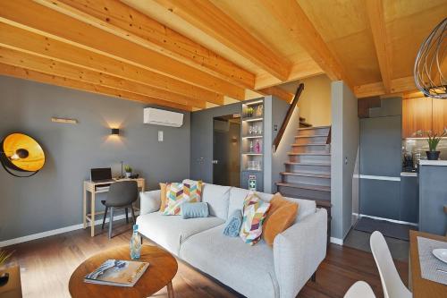 a living room with a couch and a table at Piu Bella in Fajã da Ovelha