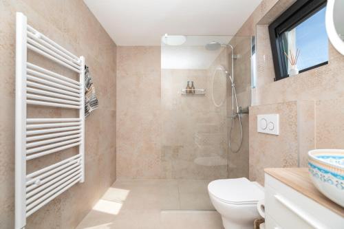 a bathroom with a toilet and a shower at Villa Andrea in Splitska