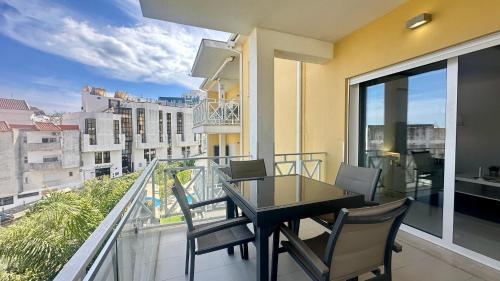 a balcony with a table and chairs on a balcony at Garden Hill M - Shared Pool - 6 Guests - Albufeira in Albufeira