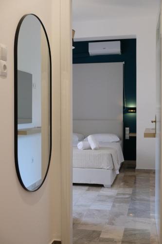 a bedroom with a mirror and a bed at Evia Blue Aura in Khrónia