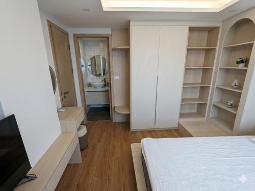 a bedroom with a bed and a sink and a mirror at Fantasea Condo Kamala 1bdr in Kamala Beach
