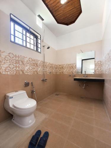 a bathroom with a toilet and a sink and a mirror at Vision 2 Islamabad in Islamabad