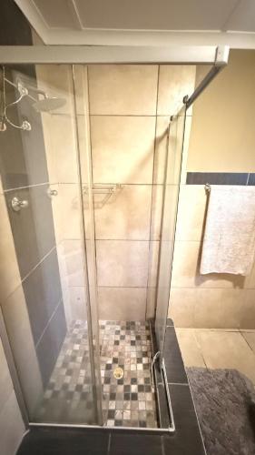a shower with a glass door in a bathroom at 2 Bedrooom Self Catering Unit, East London, 5241, South Africa, KuGompo City in Dorchester Heights 