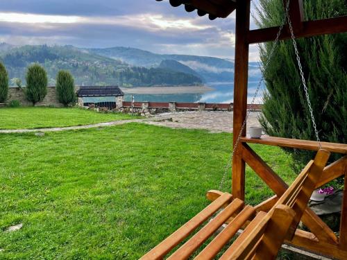 a porch swing with a view of a lake at Cabana Panoramic Bicaz in Hangul