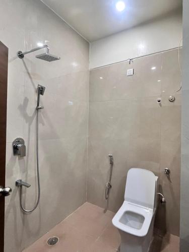 a bathroom with a shower and a toilet at MRP Residency in Chitradurga