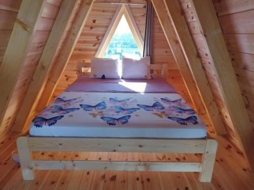 a bed in the attic of a tree house at Camp Magic View in Mojkovac