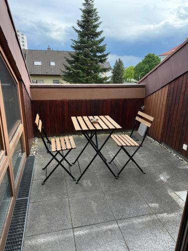 a picnic table and two chairs on a patio at Cozy Attic in Berkach