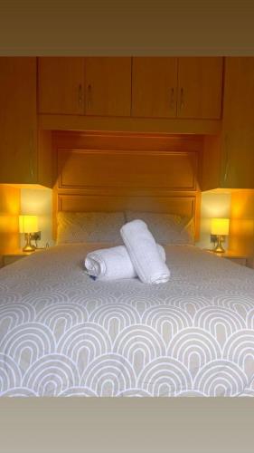 a bed with two towels on top of it at ocean view 15 in West Down