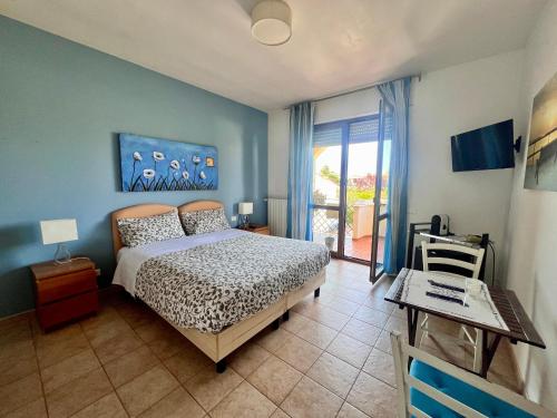 a bedroom with a bed and a table and a window at B&B La Rosa Blu in Bari