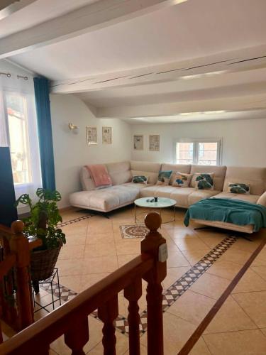a living room with a couch and a table at Coeur Cevennes in La GrandʼCombe