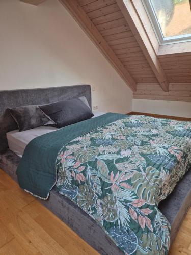 a bedroom with a bed with a colorful blanket on it at LIV Retreat in Dietenhofen