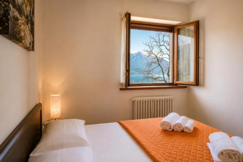 a bedroom with a bed with two rolled towels at Apartment Alex 2 in Domaso in Domaso