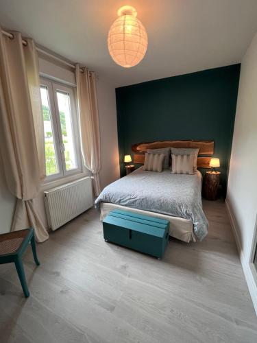 a bedroom with a bed with a blue box on the floor at GITE DE MIRAUVILLE in Apremont-la-Forêt
