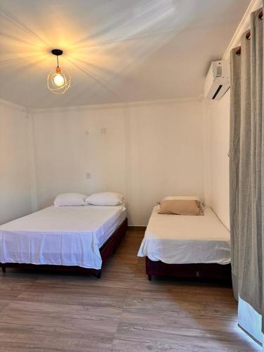 two beds in a room with at Apart Boutique EL DESCANSO in Libertador General San Martín