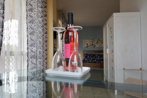 two wine bottles are sitting on a table at B&B La Rosa Blu in Bari
