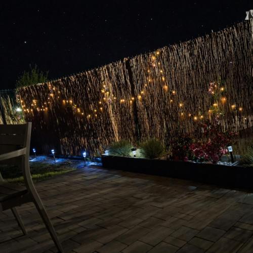 a chair sitting in front of a fountain at night at Villetta Rewal in Rewal