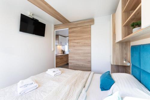 a bedroom with two beds and a tv on the wall at Floating Sea House Portorose in Portorož