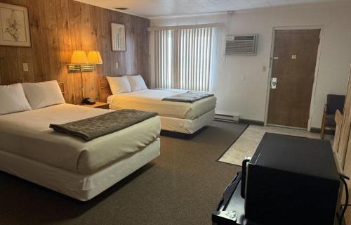 a hotel room with two beds and a television at Trade winds in Valentine