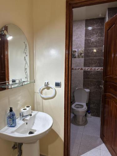 a bathroom with a sink and a toilet at Résidence Jannat in Ouarzazate