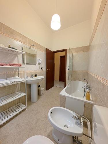 a bathroom with a toilet and a sink and a tub at millennium holiday in Castellammare del Golfo