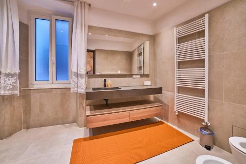 a bathroom with a sink and a mirror at Doretta's House - Luxury Apartment in Noli