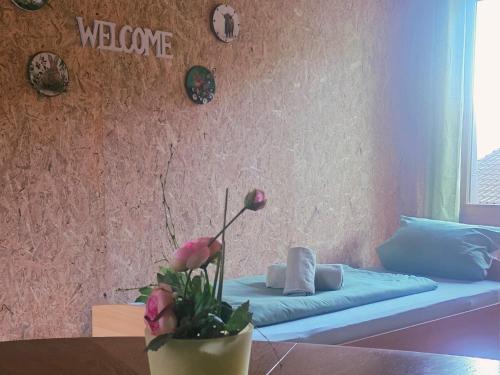 a room with a couch and a table with flowers at Cozy Cow Farm Lodge in Lucerne