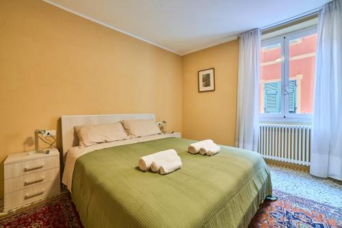 a bedroom with a bed with two towels on it at Doretta's House - Luxury Apartment in Noli