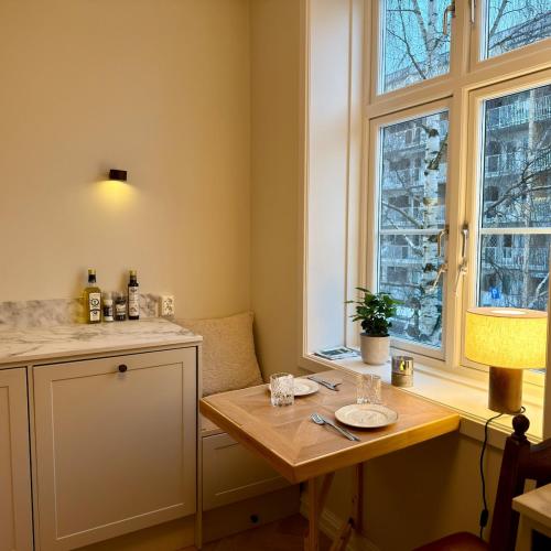 a small kitchen with a table and a window at Oslo, Classic Apartment in Oslo