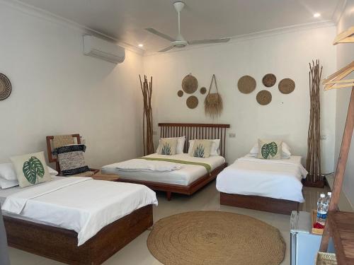 a room with two beds and a table at Minah bungalows in Nungwi