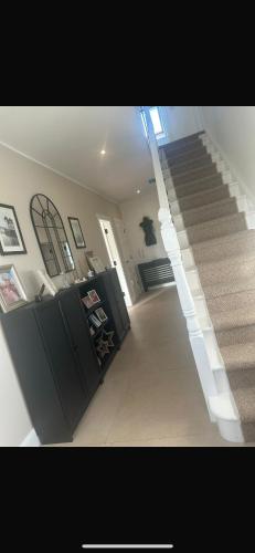 a staircase in a house with a stair case at Glenmore in Doonbeg